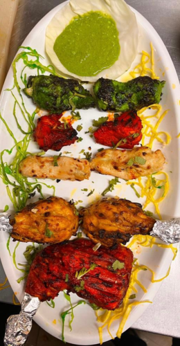 The plate is a canvas of culinary delights, showcasing an array of treats from the Indian kitchen..
