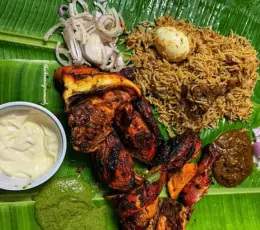 A delicious plate of food featuring Tasty Grill Chicken, accompanied by rice, eggs, and tandoori.