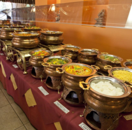 At a buffet, a mix of savory and sweet dishes is showcased, offering a wide array of food for guests